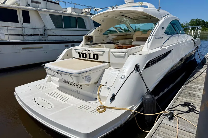 Slide: The Image of 2012 Sea Ray 410 Sundancer yacht docked, Miami Beach, FL, with "YOLO" on the stern. - 5