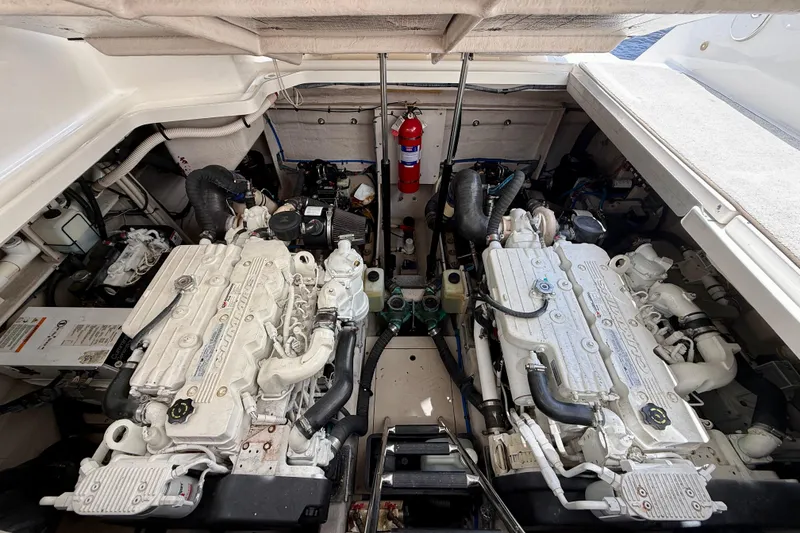 Slide: The Image of Engine compartment of a 2012 Sea Ray 410 Sundancer with dual engines and fire extinguisher. - 50