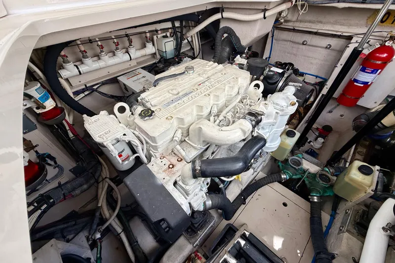 Slide: The Image of Engine compartment of a 2012 Sea Ray 410 Sundancer boat, showcasing detailed machinery. - 51