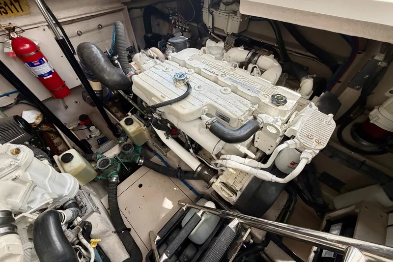 Slide: The Image of Engine room of a 2012 Sea Ray 410 Sundancer boat, showcasing mechanical components. - 52