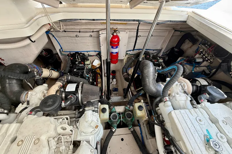 Slide: The Image of Engine room of a 2012 Sea Ray 410 Sundancer with visible components and fire extinguisher. - 53