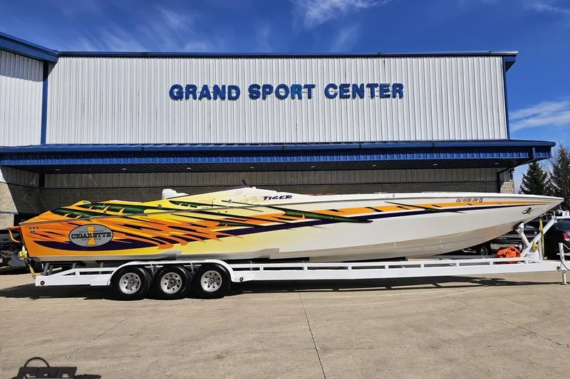The Image of 2001 Cigarette 42' Tiger boat with vibrant graphics at Grand Sport Center. - 1