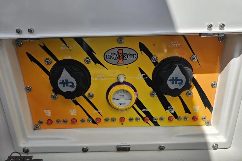Slide: The Image of Control panel of a 2001 Cigarette 42' Tiger boat with vibrant design and gauges. - 106