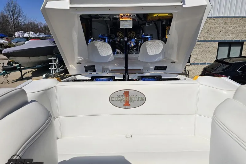 Slide: The Image of 2001 Cigarette 42' Tiger boat with open engine compartment, showcasing interior seating and logo. - 109