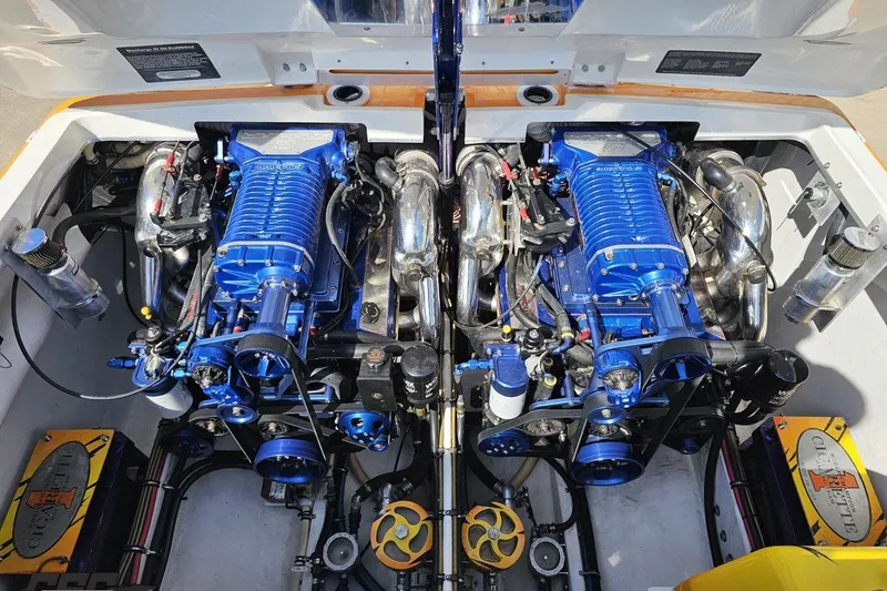 Slide: The Image of Engine compartment of a 2001 Cigarette 42' Tiger boat, featuring dual blue engines. - 112