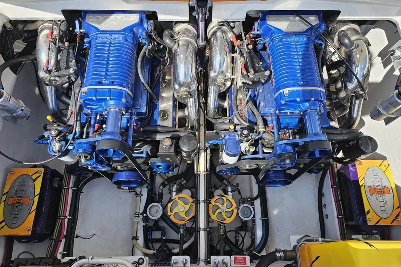 Slide: The Image of Twin blue engines in a 2001 Cigarette 42' Tiger boat, showcasing detailed mechanics. - 113