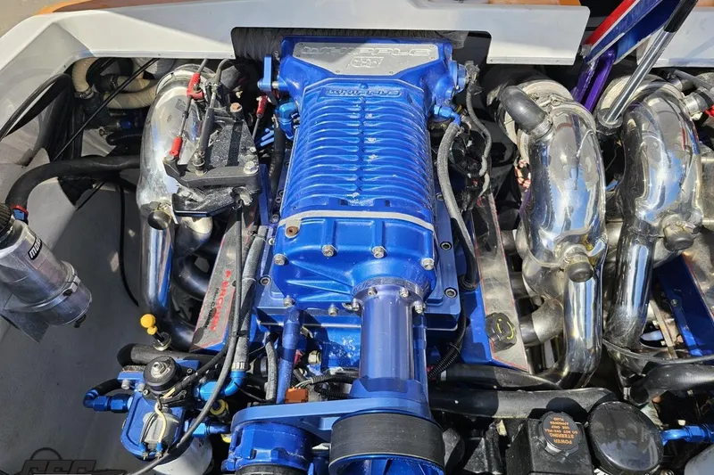 Slide: The Image of Engine of a 2001 Cigarette 42' Tiger boat, featuring a blue supercharger. - 115