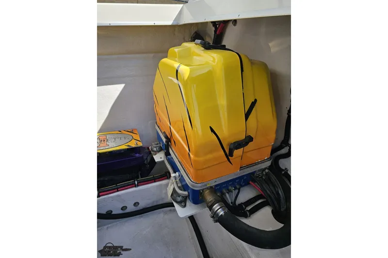 Slide: The Image of Engine compartment of a 2001 Cigarette 42' Tiger boat with yellow cover. - 116
