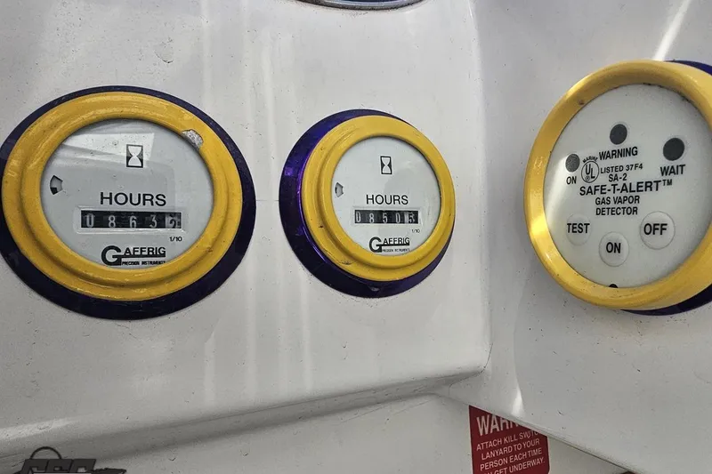Slide: The Image of Hour meters and gas vapor detector on a 2001 Cigarette 42' Tiger boat dashboard. - 117