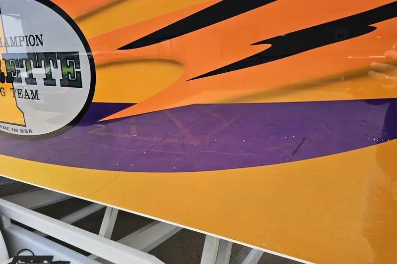 Slide: The Image of Close-up of 2001 Cigarette 42' Tiger boat with vibrant orange and purple graphics. - 119