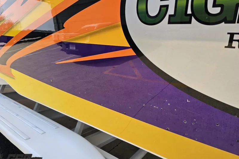 Slide: The Image of Colorful graphics on a 2001 Cigarette 42' Tiger boat hull. - 120