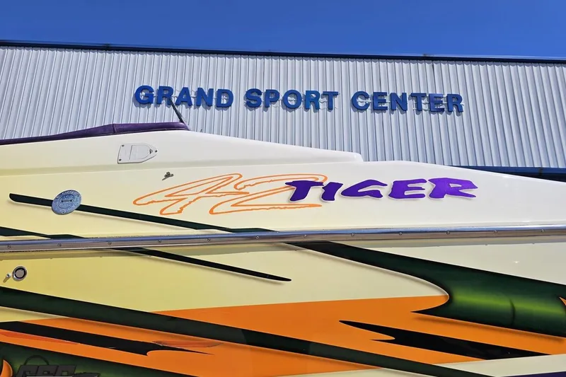 Slide: The Image of 2001 Cigarette 42' Tiger boat at Grand Sport Center, vibrant graphics. - 13