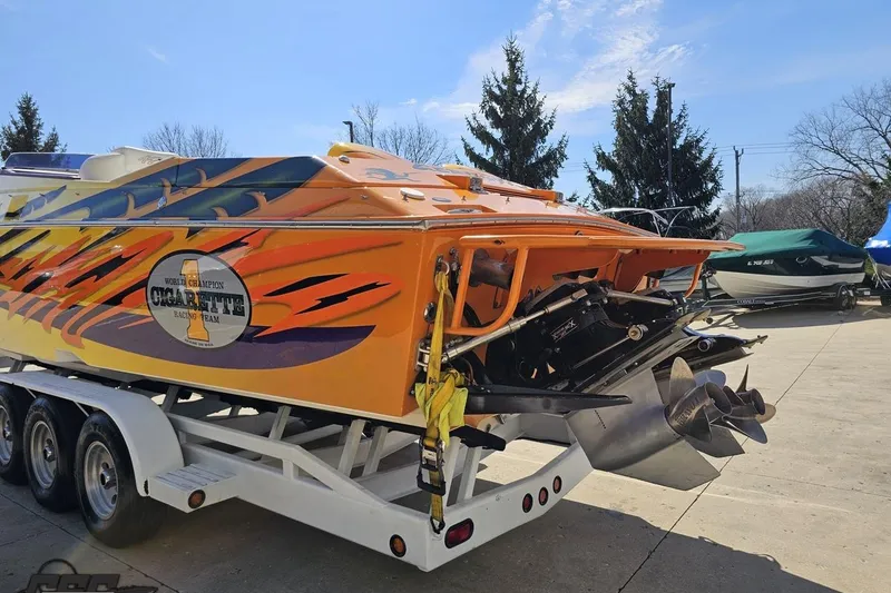 Slide: The Image of 2001 Cigarette 42' Tiger powerboat with vibrant graphics on a trailer. - 38