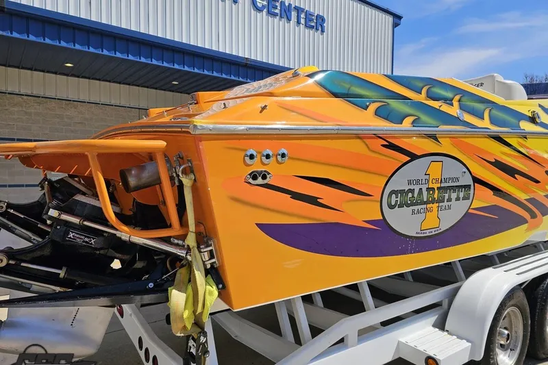 Slide: The Image of 2001 Cigarette 42' Tiger powerboat with vibrant racing graphics on a trailer. - 41