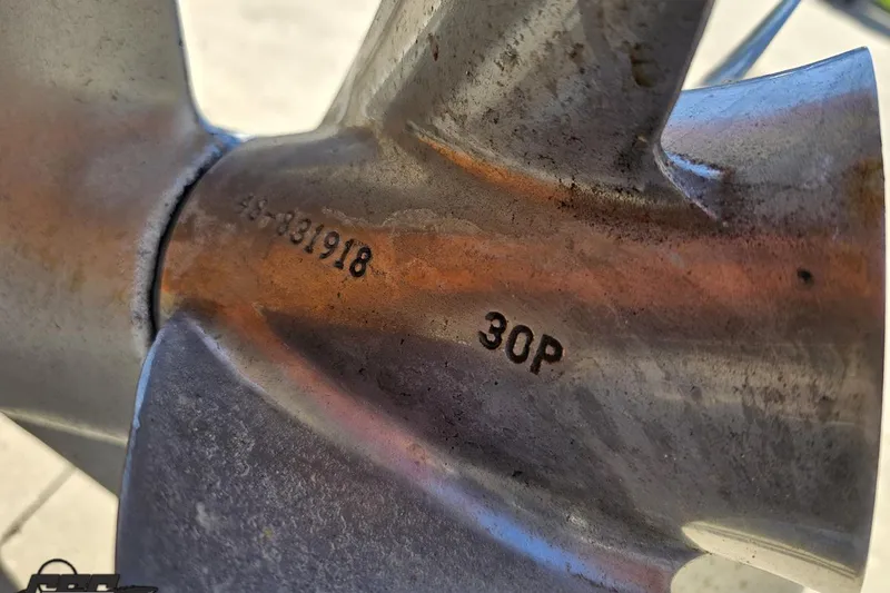 Slide: The Image of Close-up of a metal propeller with engraved numbers, for a 2001 Cigarette 42' Tiger boat. - 43