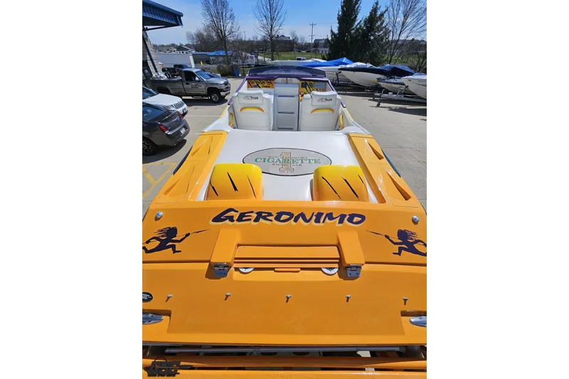 Slide: The Image of 2001 Cigarette 42' Tiger boat, vibrant yellow, parked outdoors with "Geronimo" text. - 48