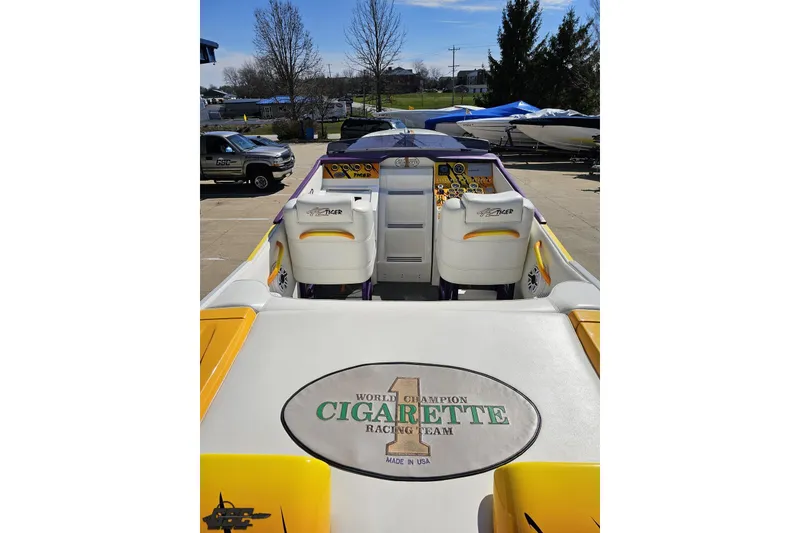 Slide: The Image of 2001 Cigarette 42' Tiger boat interior with racing team branding, parked outdoors. - 52
