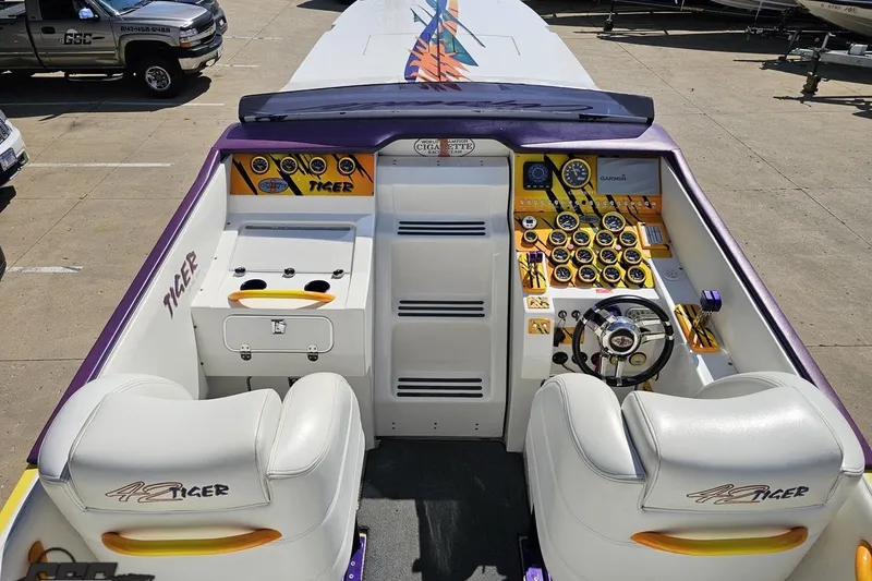 Slide: The Image of 2001 Cigarette 42' Tiger boat cockpit with vibrant controls and seating. - 56