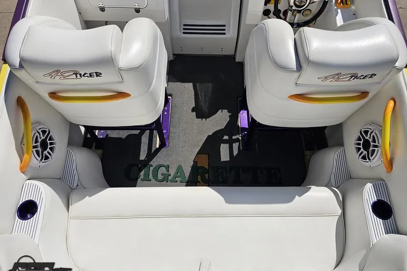 Slide: The Image of Interior of a 2001 Cigarette 42' Tiger boat with white seating and branded carpet. - 57