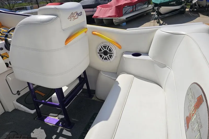 Slide: The Image of Interior of a 2001 Cigarette 42' Tiger boat with white seating and speaker. - 60
