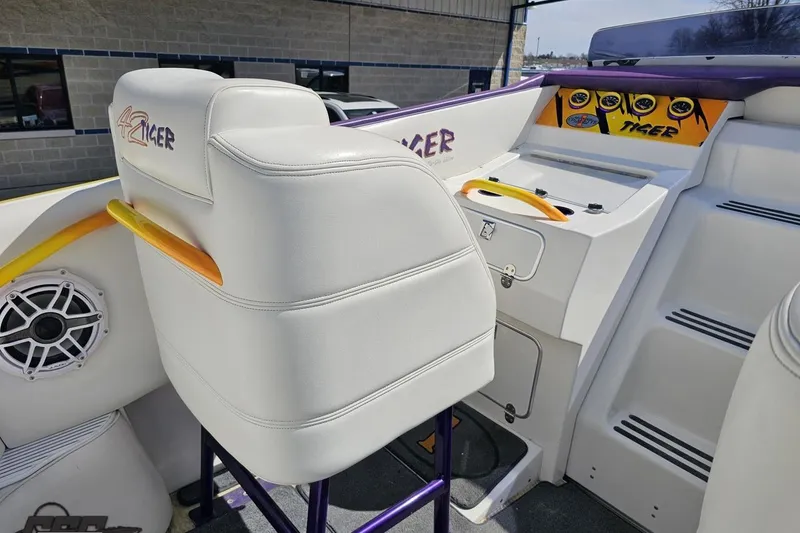 Slide: The Image of Interior of a 2001 Cigarette 42' Tiger boat with white seating and dashboard. - 62