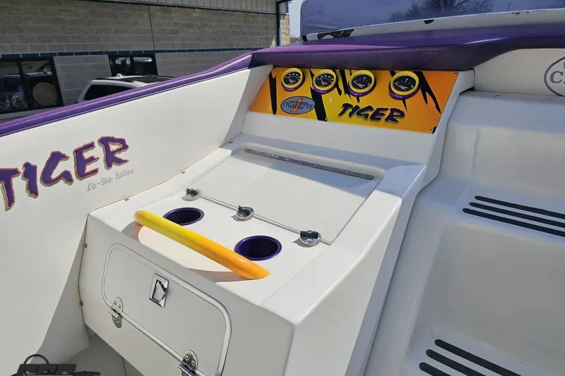 Slide: The Image of 2001 Cigarette 42' Tiger boat dashboard with vibrant gauges and cup holders. - 64