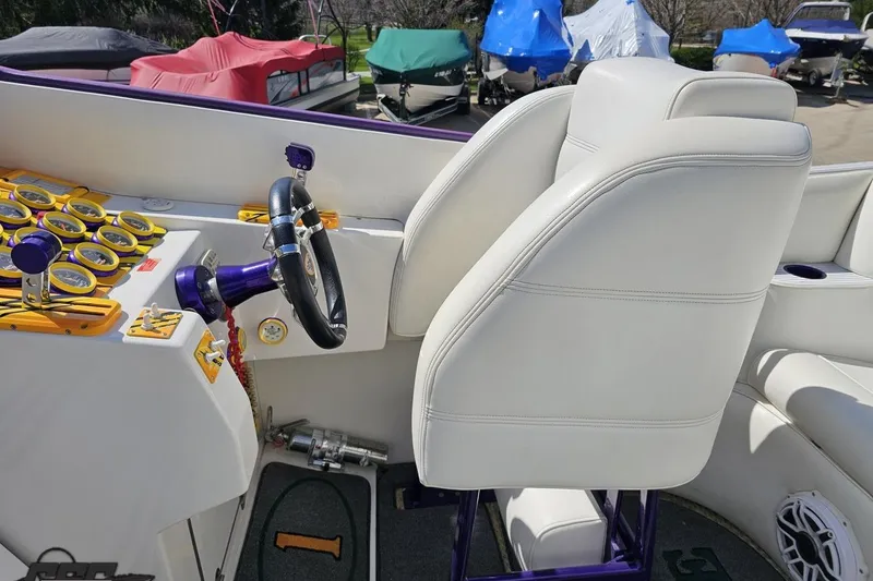 Slide: The Image of Interior of a 2001 Cigarette 42' Tiger boat with white seating and vibrant dashboard. - 65