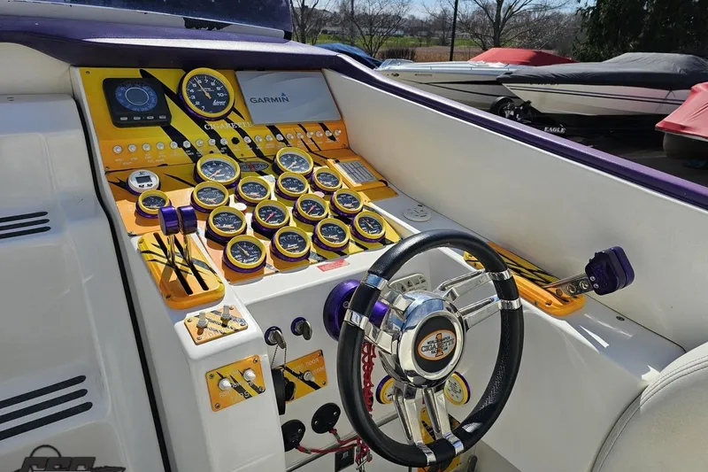 Slide: The Image of Cockpit of a 2001 Cigarette 42' Tiger boat with vibrant gauges and steering wheel. - 66