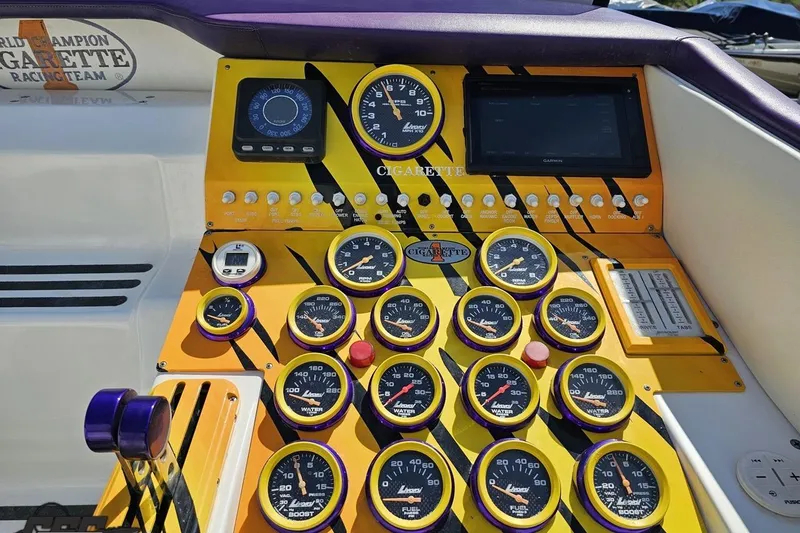Slide: The Image of Dashboard of a 2001 Cigarette 42' Tiger boat with vibrant gauges and controls. - 68