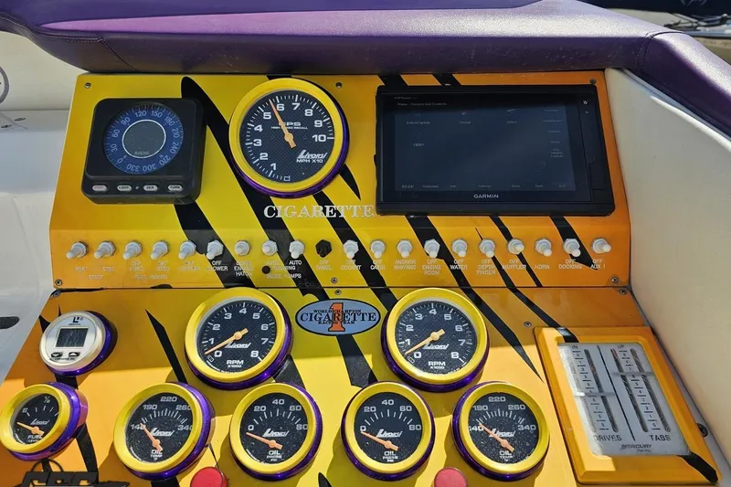 Slide: The Image of Dashboard of a 2001 Cigarette 42' Tiger boat with gauges and controls. - 69