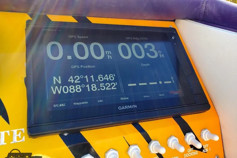 Slide: The Image of Garmin GPS display on 2001 Cigarette 42' Tiger boat showing coordinates and speed. - 71