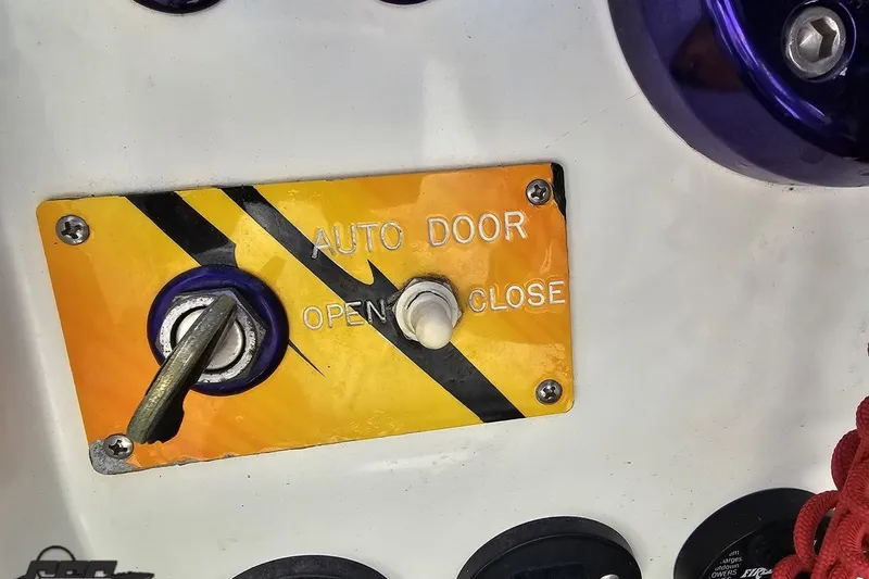 Slide: The Image of Auto door control panel on 2001 Cigarette 42' Tiger boat dashboard. - 72