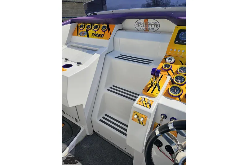 Slide: The Image of Cockpit of 2001 Cigarette 42' Tiger boat with vibrant gauges and controls. - 73