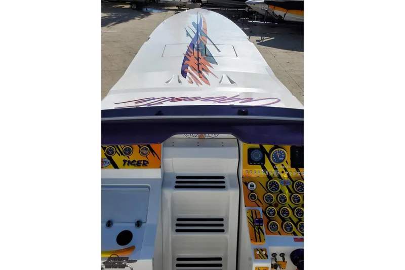 Slide: The Image of 2001 Cigarette 42' Tiger boat dashboard with vibrant graphics and controls. - 74