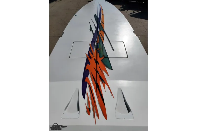 Slide: The Image of 2001 Cigarette 42' Tiger boat with vibrant orange and purple graphics on deck. - 77