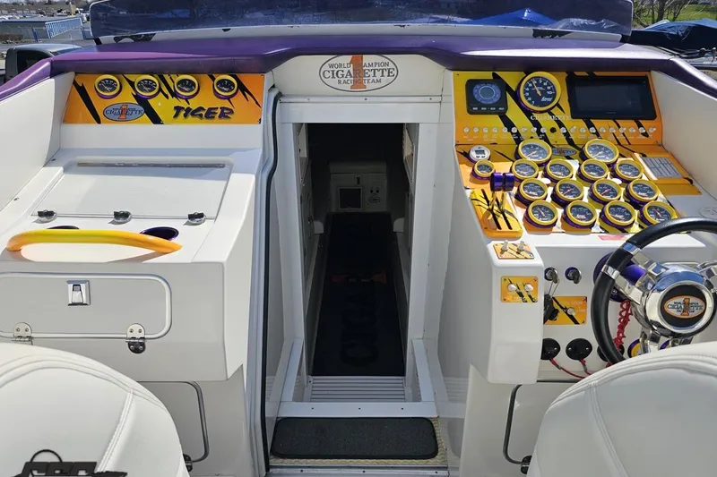 Slide: The Image of Cockpit of 2001 Cigarette 42' Tiger boat with vibrant dashboard and controls. - 80