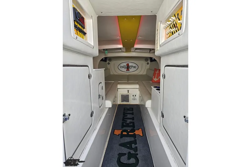 Slide: The Image of Interior of a 2001 Cigarette 42' Tiger boat, featuring white cabinetry and seating. - 81
