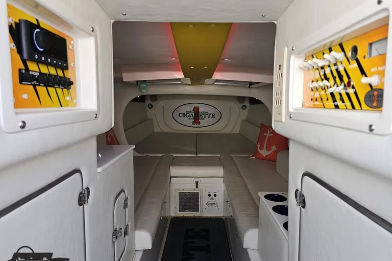 Slide: The Image of Interior of a 2001 Cigarette 42' Tiger boat, featuring white seating and control panels. - 82