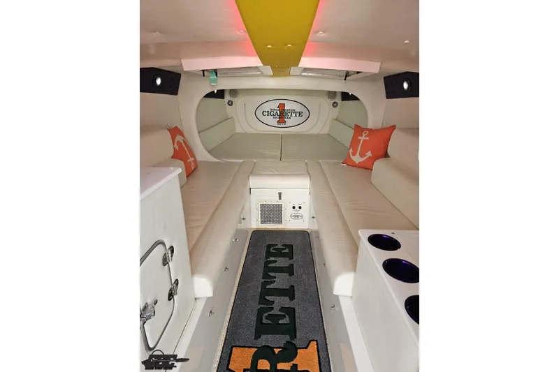 Slide: The Image of Interior of a 2001 Cigarette 42' Tiger boat with white seating and nautical decor. - 84