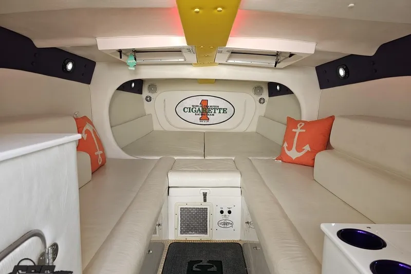 Slide: The Image of Interior of 2001 Cigarette 42' Tiger boat with white seating and anchor-themed pillows. - 85