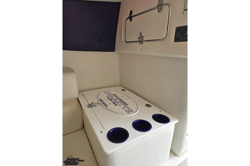 Slide: The Image of Interior of a 2001 Cigarette 42' Tiger boat featuring a storage compartment and cup holders. - 86