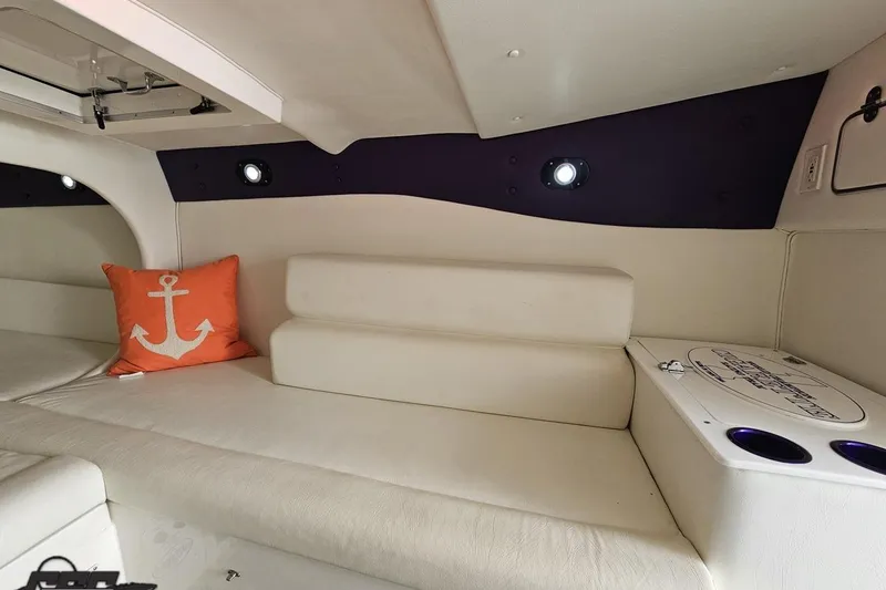 Slide: The Image of Interior of a 2001 Cigarette 42' Tiger boat with white seating and anchor-themed pillow. - 88