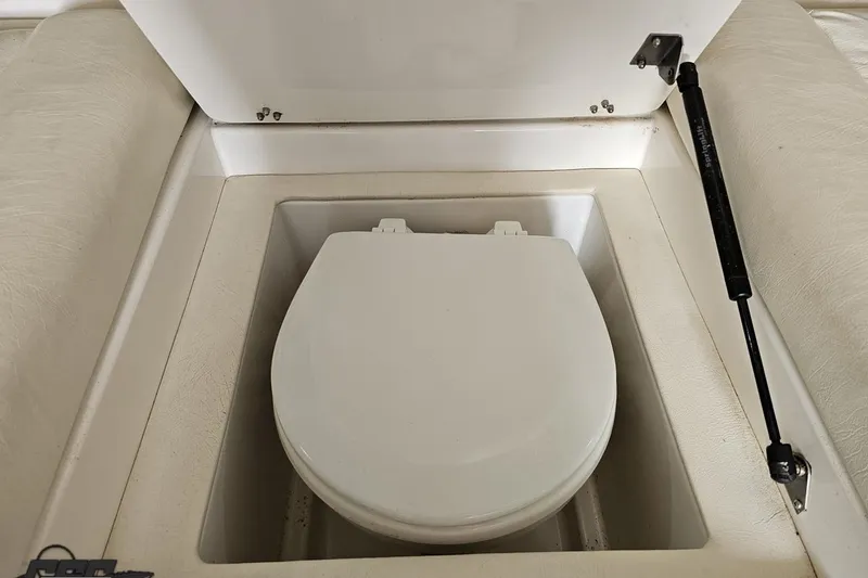 Slide: The Image of 2001 Cigarette 42' Tiger boat interior with a built-in toilet compartment. - 90