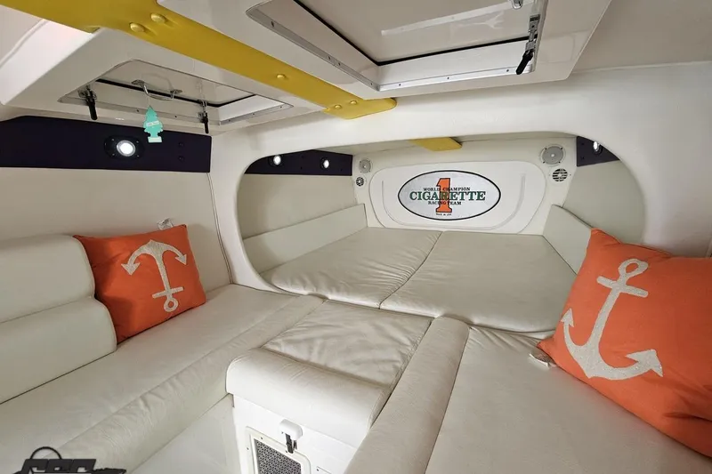 Slide: The Image of Interior of 2001 Cigarette 42' Tiger boat with white seating and anchor-themed pillows. - 92