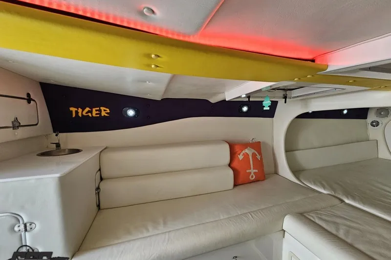Slide: The Image of Interior of 2001 Cigarette 42' Tiger boat with white seating and orange anchor pillow. - 93