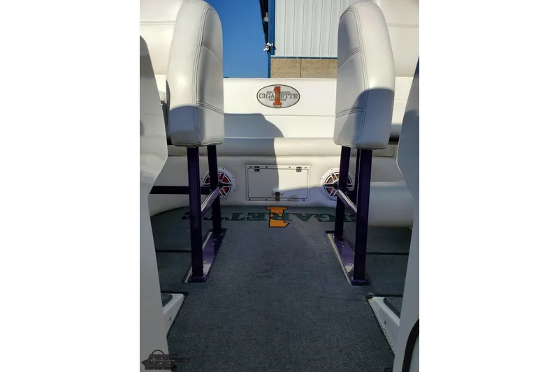 Slide: The Image of Interior of a 2001 Cigarette 42' Tiger boat with white seating and carpeted floor. - 97
