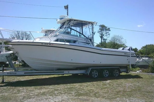 The Image of 2000 Grady-White Sailfish 272 boat on trailer, side view, outdoors. - 1