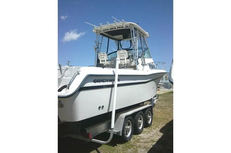 Slide: The Image of 2000 Grady-White Sailfish 272 boat on trailer under clear blue sky. - 10