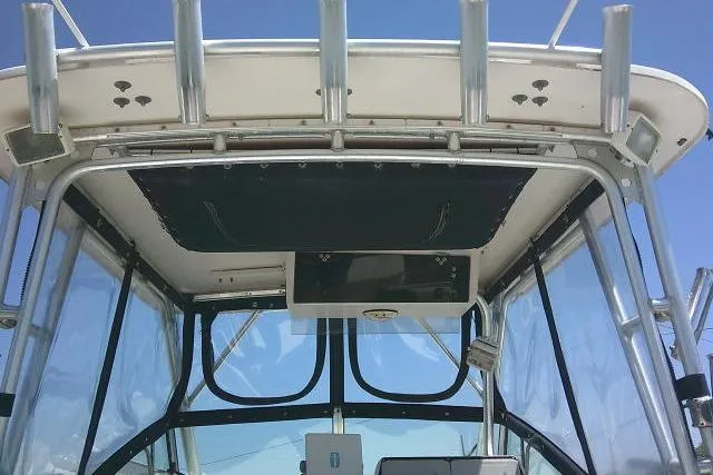 Slide: The Image of Grady-White Sailfish 272 boat cockpit view, showcasing helm and canopy, 2000 model. - 21