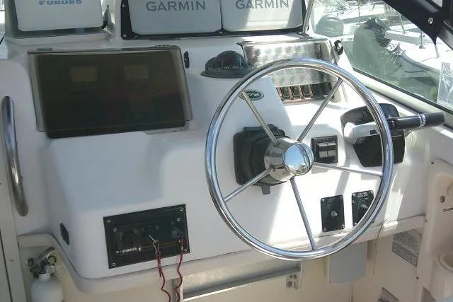 Slide: The Image of Helm of 2000 Grady-White Sailfish 272 with Garmin navigation systems and steering wheel. - 28
